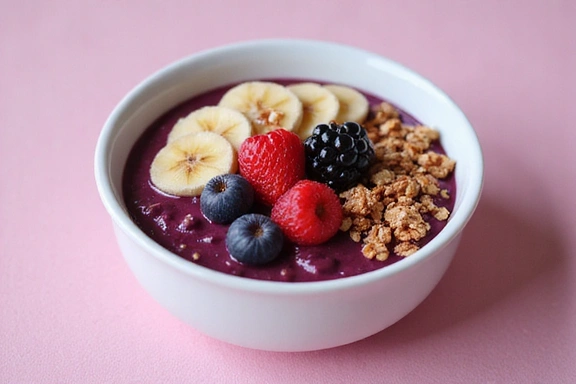 Una ciotola di acai con frutta fresca e cereali, che rappresenta una colazione sana e nutriente.